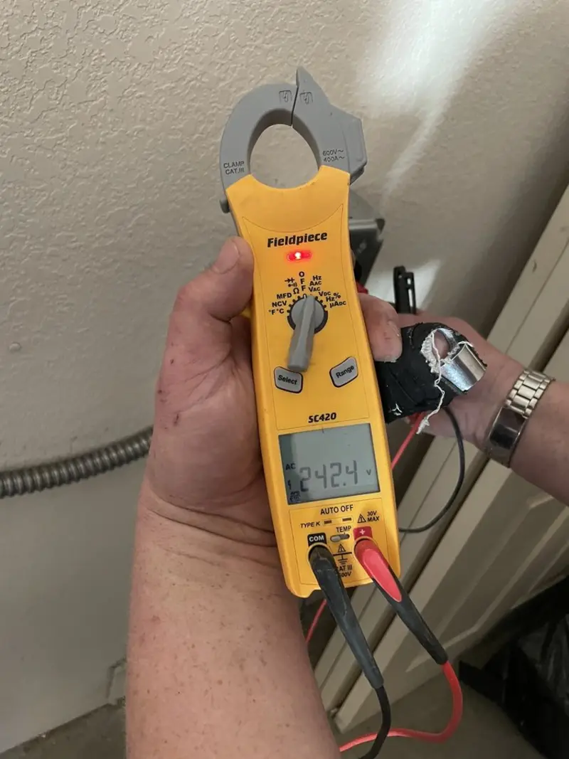 Voltage testing with clamp meter during Electrical Installation Services in Algona